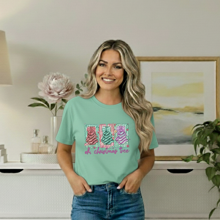 Woman wearing a light green t-shirt with colorful text design in a room with decor elements.