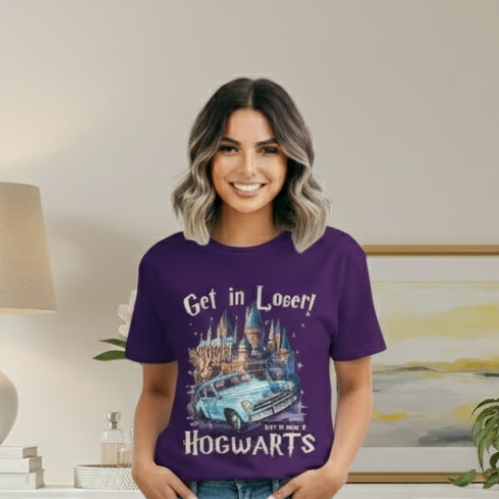 Woman wearing a purple t-shirt with a castle graphic and text, standing in a room with a lamp and painting.