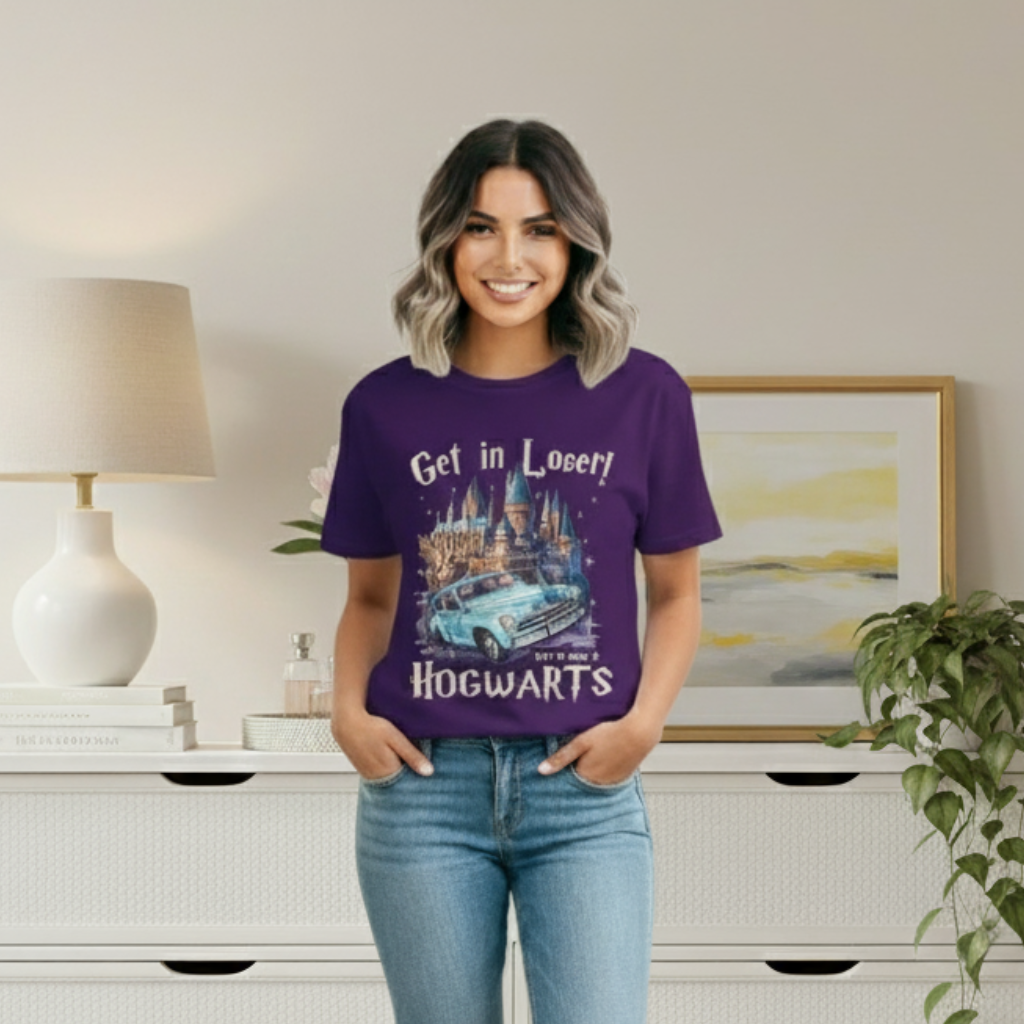 Woman wearing a purple t-shirt with a castle design and text, standing in a room with a lamp and painting.