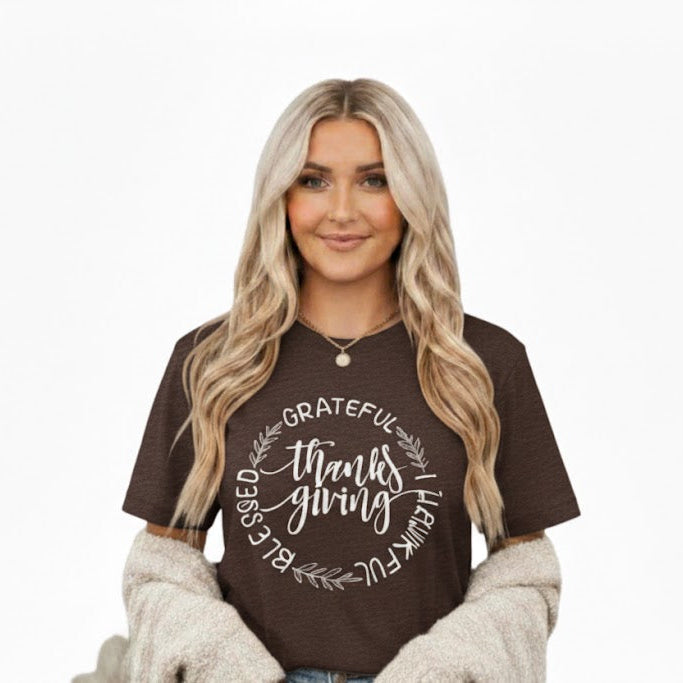 Woman wearing a brown t-shirt with 'grateful thankful blessed' text on a white background